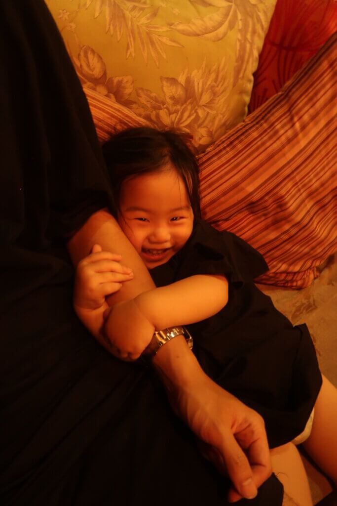 Sweetie beams with joy, surrounded by the love and laughter of family.